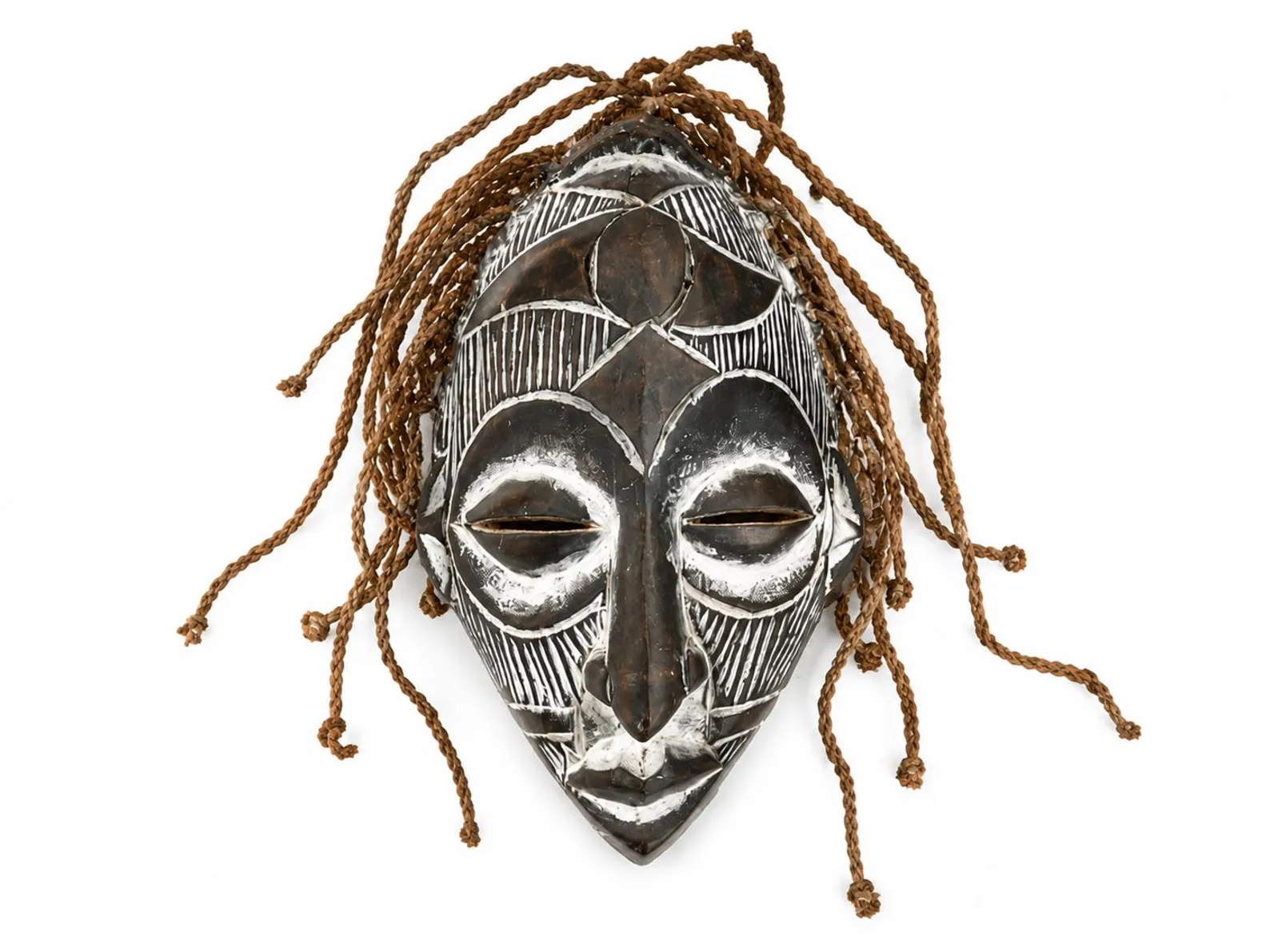 Carved African wooden mask wall art with white geometric details and natural fiber accents