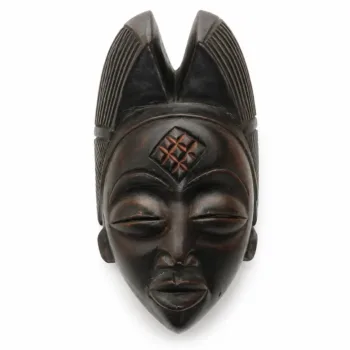 African wooden mask with carved geometric details and elongated headdress