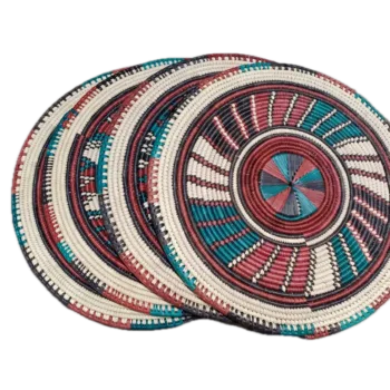 Round handwoven rattan placemat with colourful concentric woven pattern