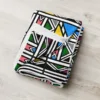 Ndebele African print throw blanket with colourful geometric pattern on a chair