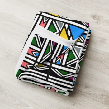 Ndebele African print throw blanket with colourful geometric pattern on a chair