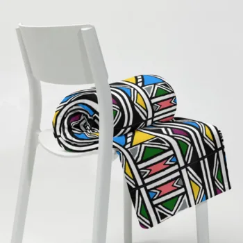Ndebele African print throw blanket with colourful geometric pattern on a chair