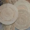 Handwoven round natural rattan placemat with concentric woven design
