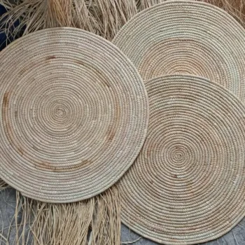 Handwoven round natural rattan placemat with concentric woven design