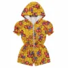 Woman wearing a vibrant yellow and coral African print hooded jumpsuit with front zipper and hood – Ankara hoodie jacket for ladies.