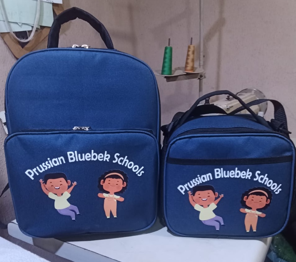 See how African Things produced 123 branded backpacks and lunch boxes for Prussian Bluebek Schools. Bulk school bag and lunch box manufacturing for schools in Nigeria.