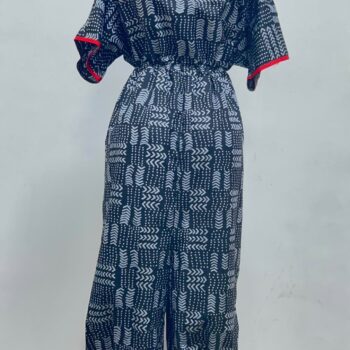 Women's African print harem jumpsuit in black and white geometric pattern with red V-neck trim and tapered ankles