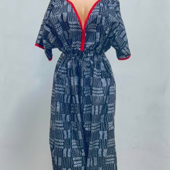 Women's African print harem jumpsuit in black and white geometric pattern with red V-neck trim and tapered ankles