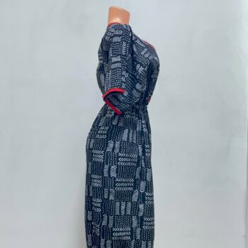 Women's African print harem jumpsuit in black and white geometric pattern with red V-neck trim and tapered ankles