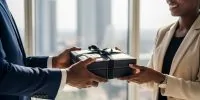 Two Nigerian corporate individuals exchanging gifts