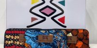 Vibrant African print female wallet with colorful patterns, multiple compartments, and a secure closure for style and functionality.