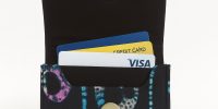 Ankara African print card holder with blue dotted patterns, open with credit cards inside.