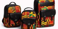 Three-piece set of African print backpacks – A group of three structured backpacks in small, medium, and large sizes, featuring bold Kente-inspired print in yellow, orange, green, and red, combined with black leather panels and pockets, displayed on a clean white background.